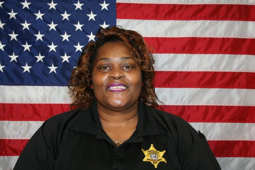 Lt. Miria Rainey with American Flag backdrop