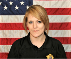 Sgt. Kayla Thompson with American Flag backdrop