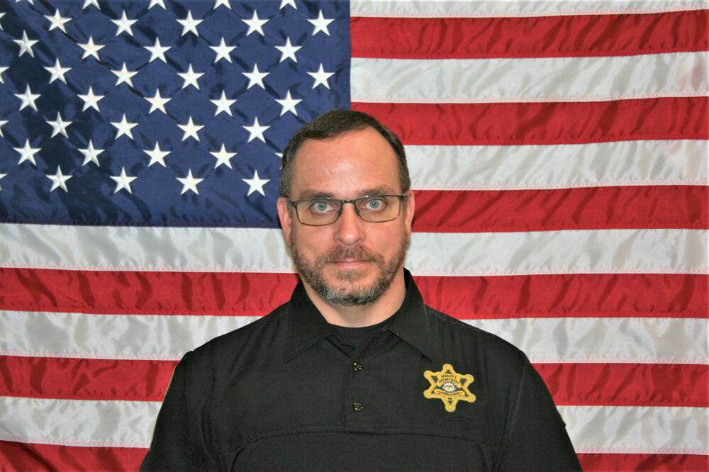 School Resource Deputy Casey McElhenney with American Flag Backdrop