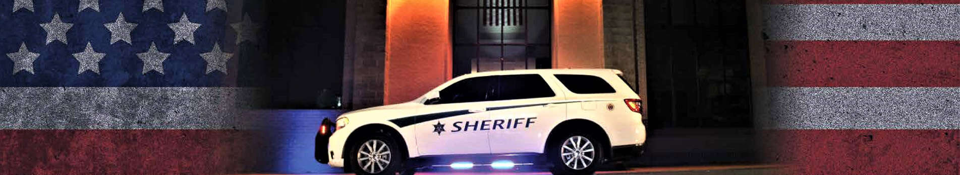 Sheriff SUV parked in front of a building.