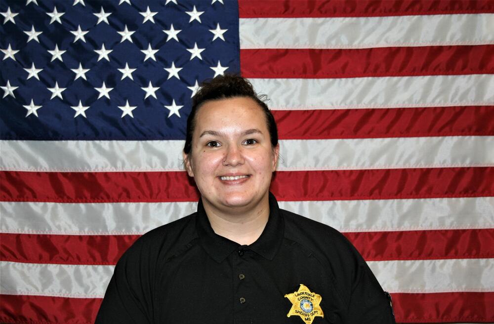 Sgt Brittani Waggoner in front of the American Flag