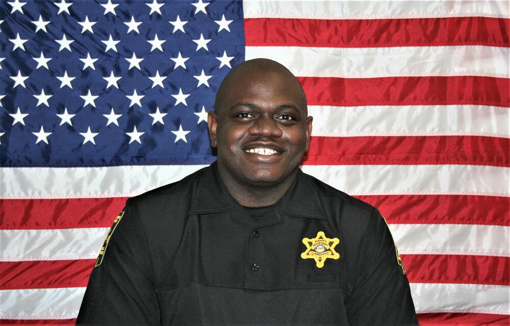 SRO Randle in front of American Flag