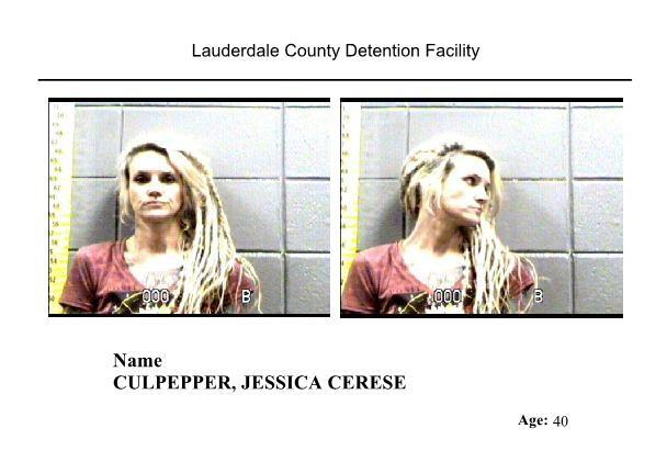 Blond female in jail taking mugshot after arrest