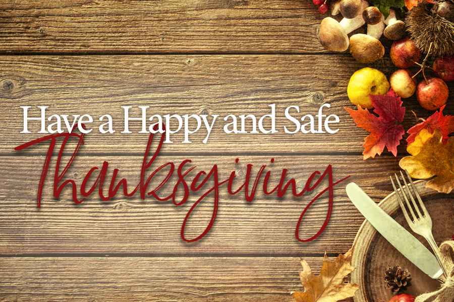 Brightly colored leaves, green apples, orange pumpkings a knife, fork and plate on a wood floor background. Happy and Safe Thanksgiving!