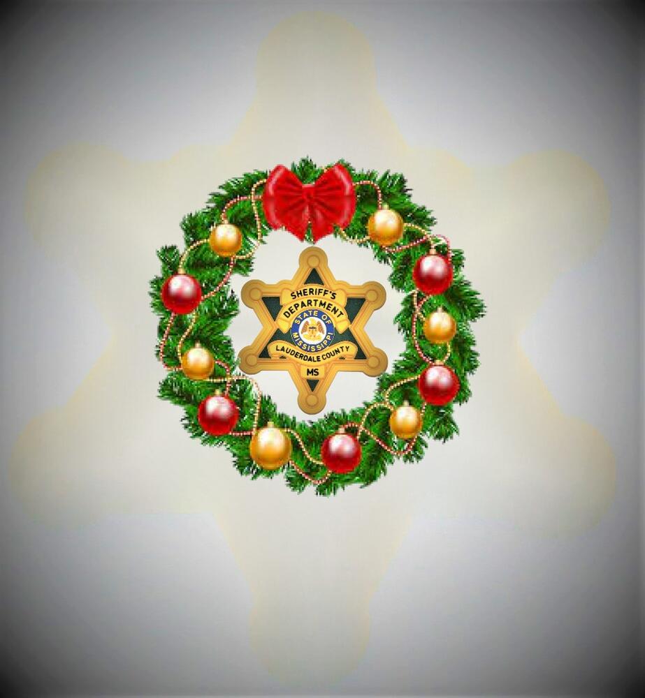 Gold, green and black Sheriff's badge with a green wreath bearing gold and red balls and a red ribbon