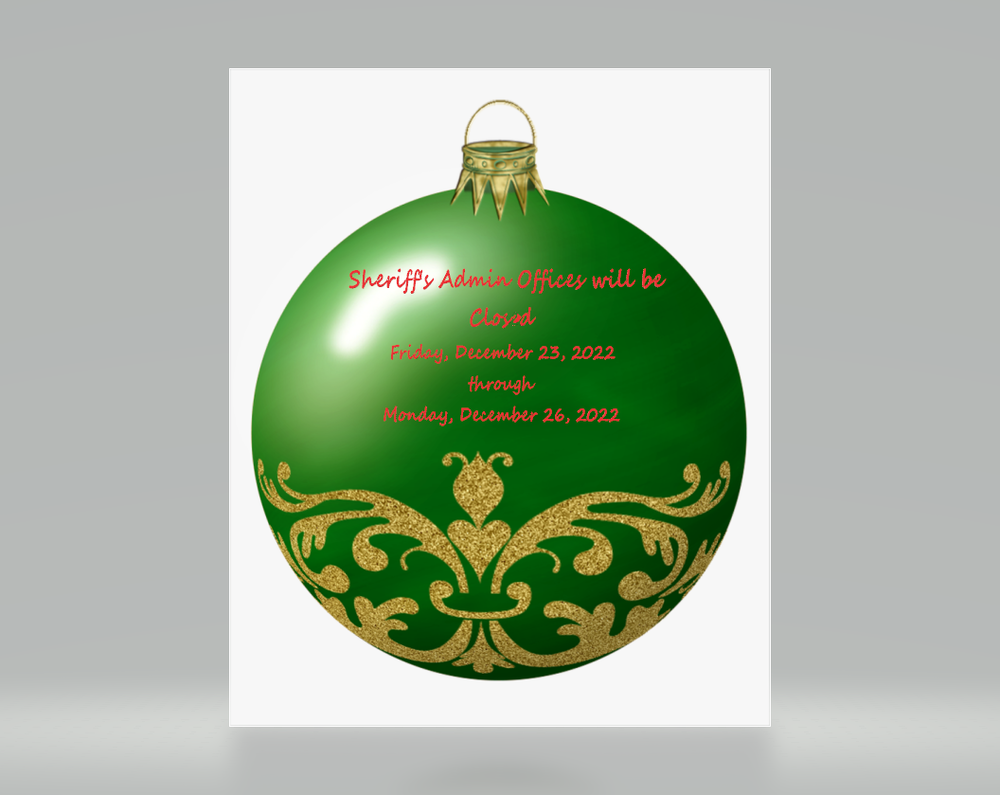 Green and gold christmas ball with holiday office closings.
