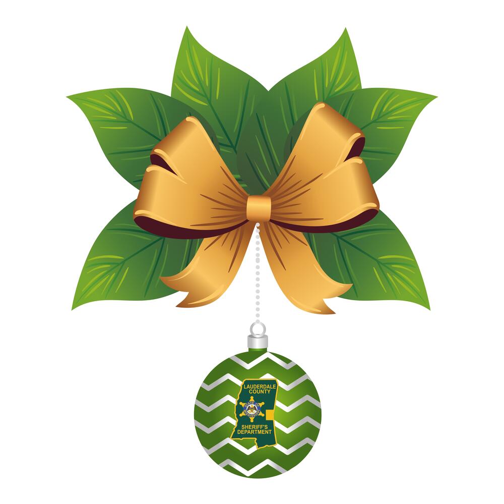 Gold bow on green leaves with a green christmas ball with jagged white lines. The LCSO patch of MS is in the ball.