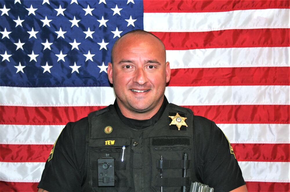White male with dark hair wearing a Sheriff's Office polo.